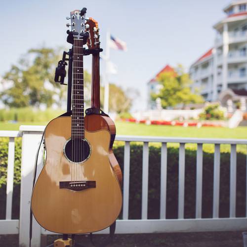 Acoustic guitar displayed on stand on outdoor patio of Inn at Bay Harbor