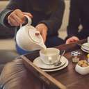 Woman pours tea for her husband