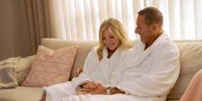 Couple relaxing in robes on couch, The Spa at Inn at Bay Harbor