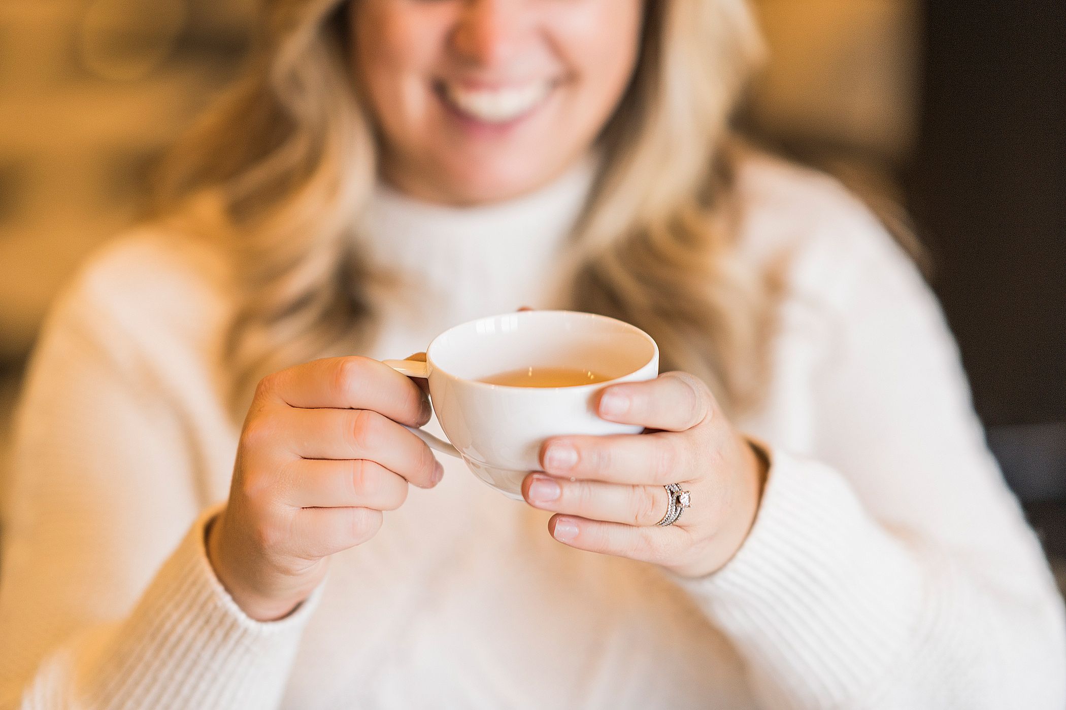 Woman holding hot tea cup