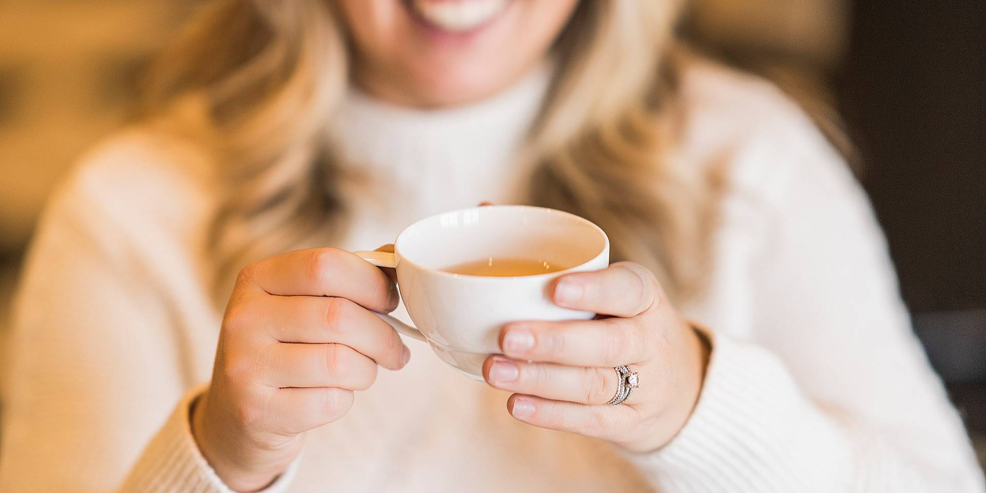 Woman holding hot tea cup