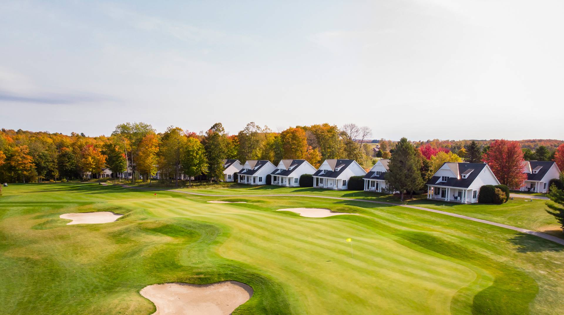 Lush autumn golf course lined by Crooked Tree Cottages