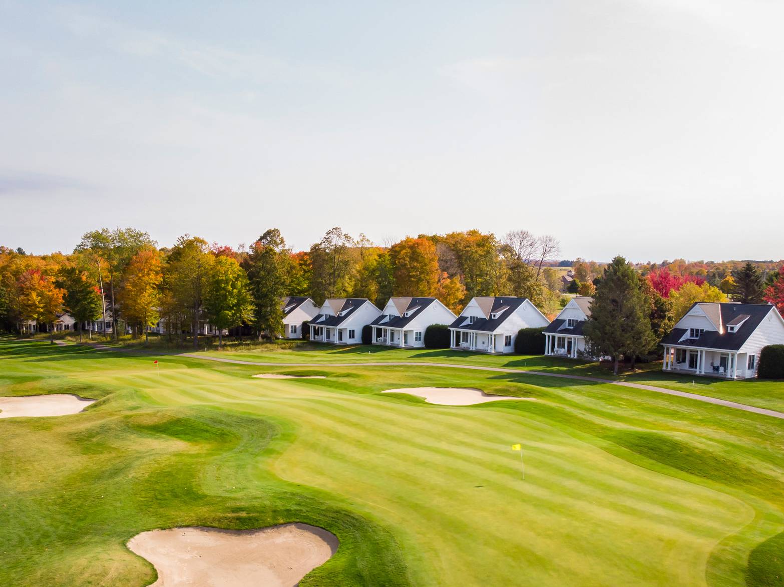 Lush autumn golf course lined by Crooked Tree Cottages