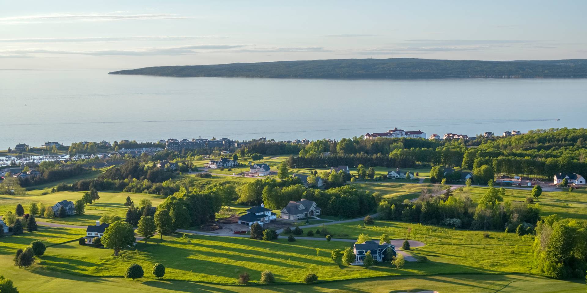 Aerial view of scenic golf course at Inn at Bay Harbor, surrounded by lush greenery and overlooking Lake Michigan, Inn at Bay Harbor