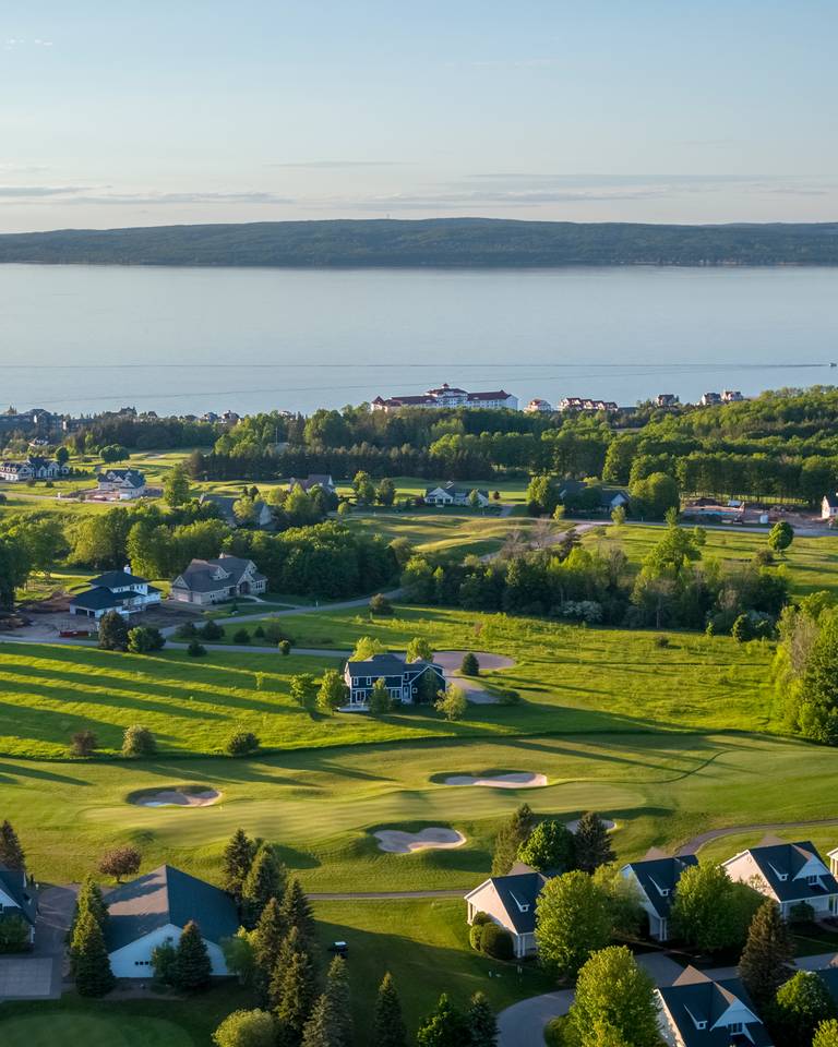 Aerial view of scenic golf course at Inn at Bay Harbor, surrounded by lush greenery and overlooking Lake Michigan, Inn at Bay Harbor