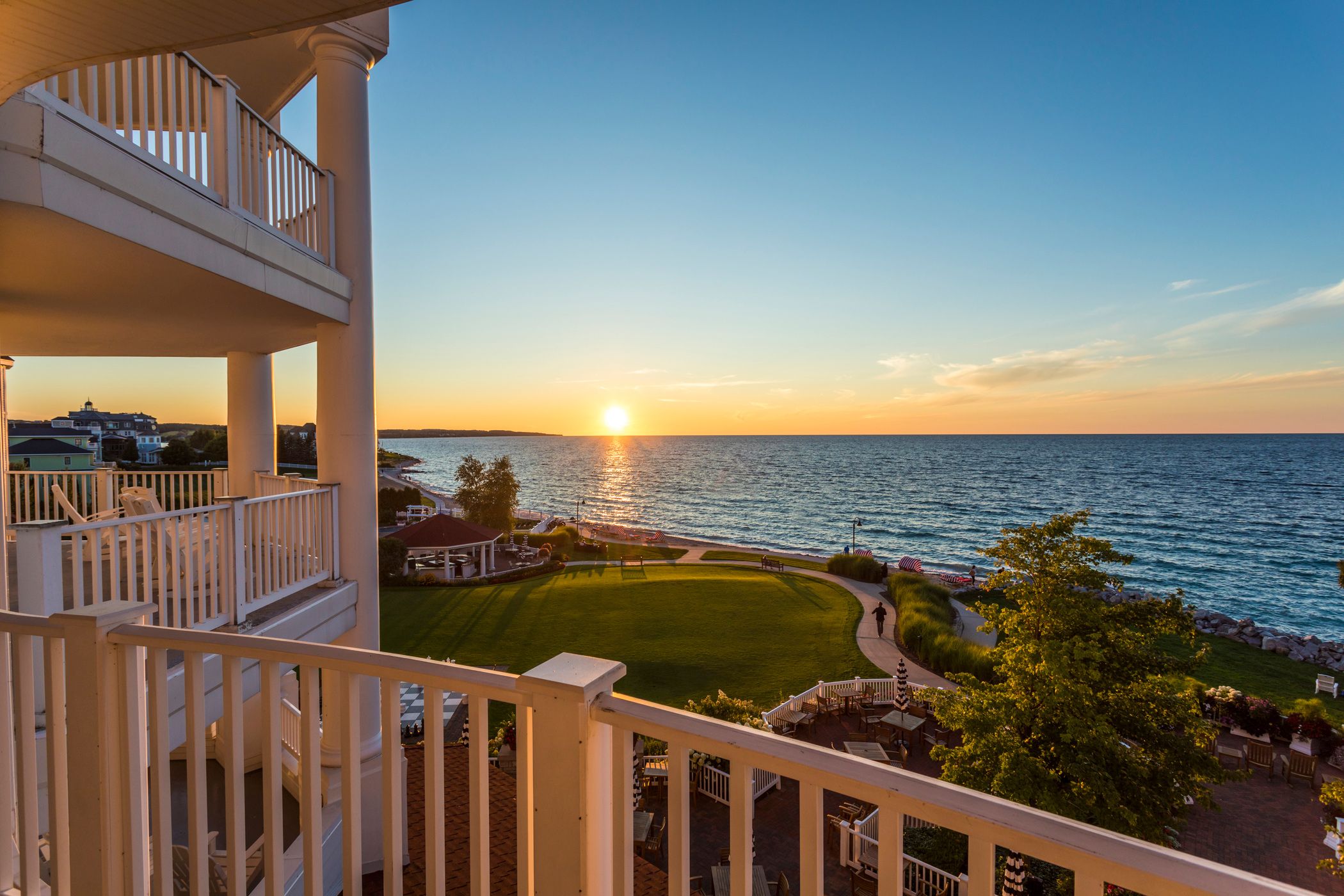 Gold sunset over Lake Michigan, lush beach and grounds from balcony of Inn at Bay Harbor