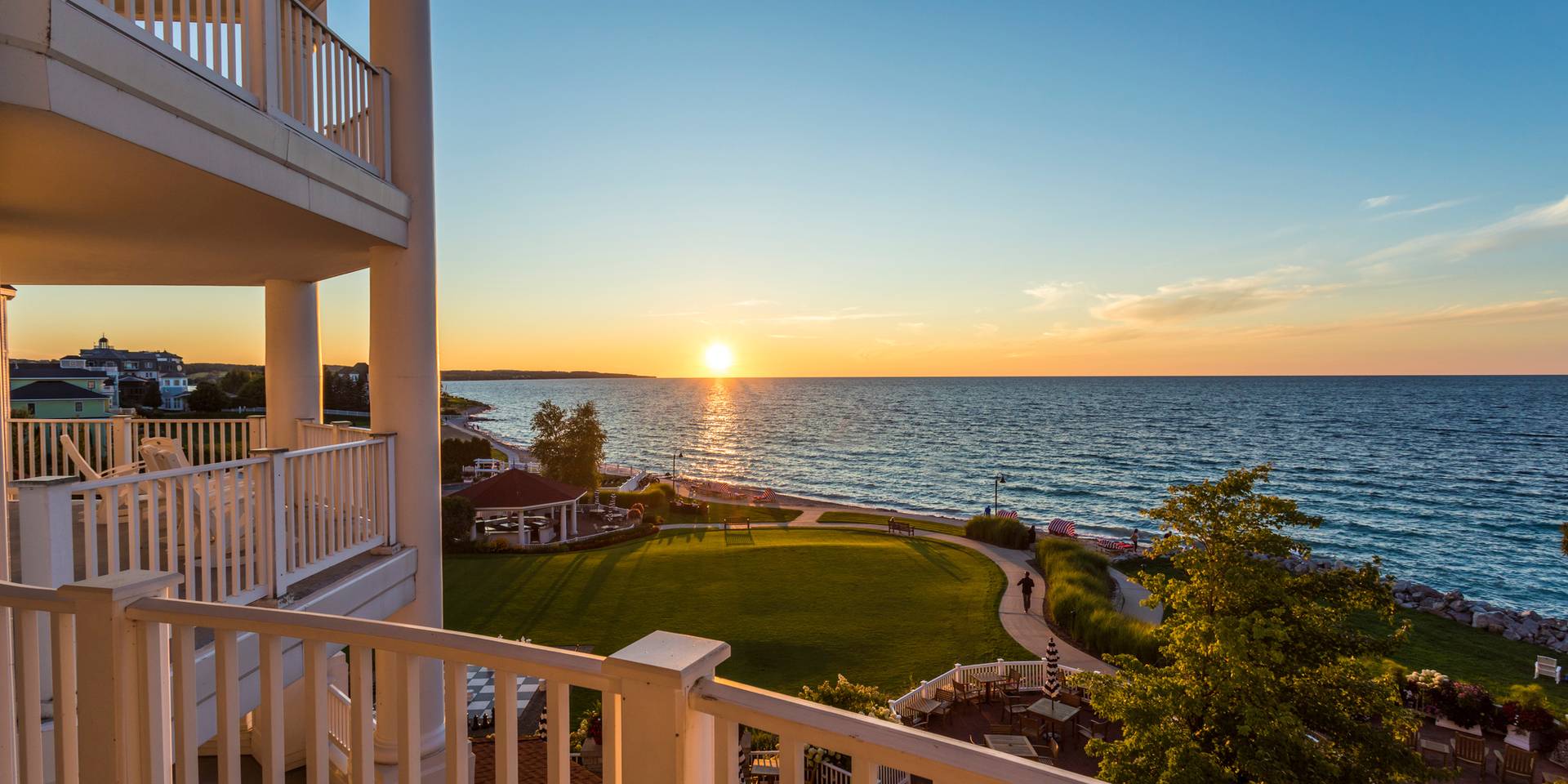Gold sunset over Lake Michigan, lush beach and grounds from balcony of Inn at Bay Harbor