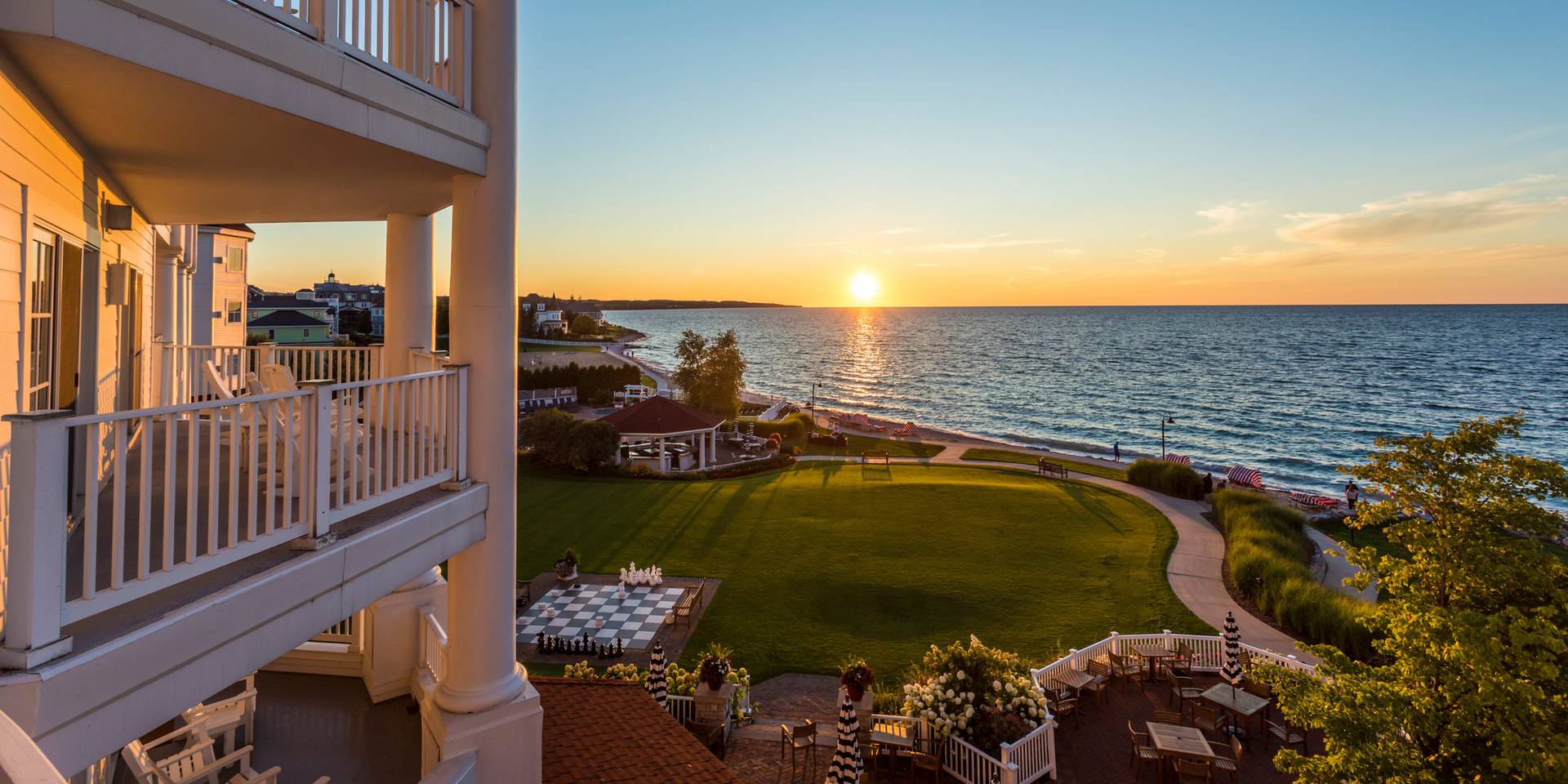 Exterior balcony detail overlooking gold sunset over Lake Michigan, Inn at Bay Harbor grounds