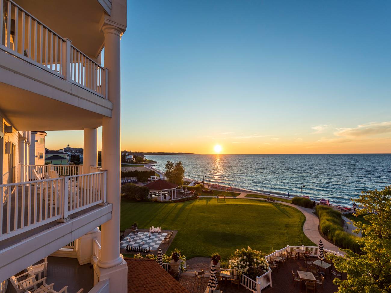 Exterior balcony detail overlooking gold sunset over Lake Michigan, Inn at Bay Harbor grounds