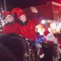 Elves in costume wave in evening Boiyne City holiday parade