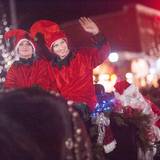 Elves in costume wave in evening Boiyne City holiday parade