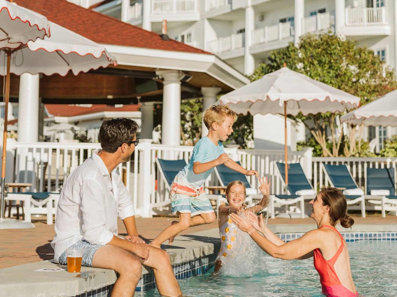 Family playing in outdoor pool, Inn at Bay Harbor