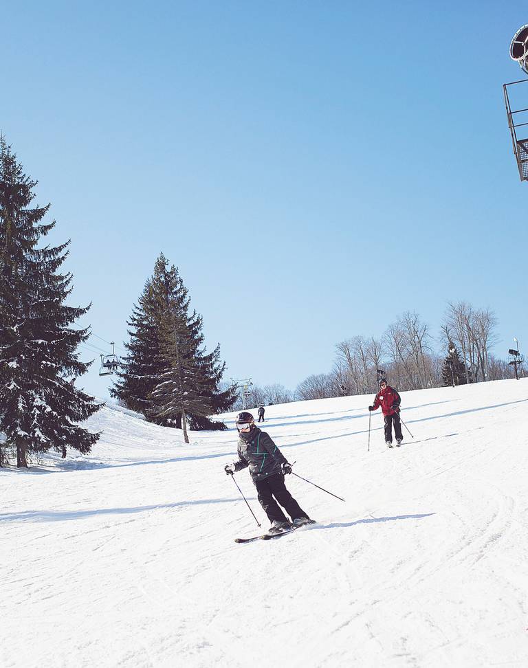 Skier on sunny ski hill