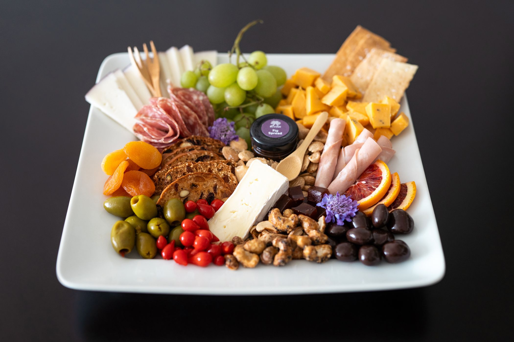 Colorful meat, cheese, and fruit charcuterie tray