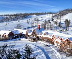 A drone shot of The Highlands Main Lodge in winter