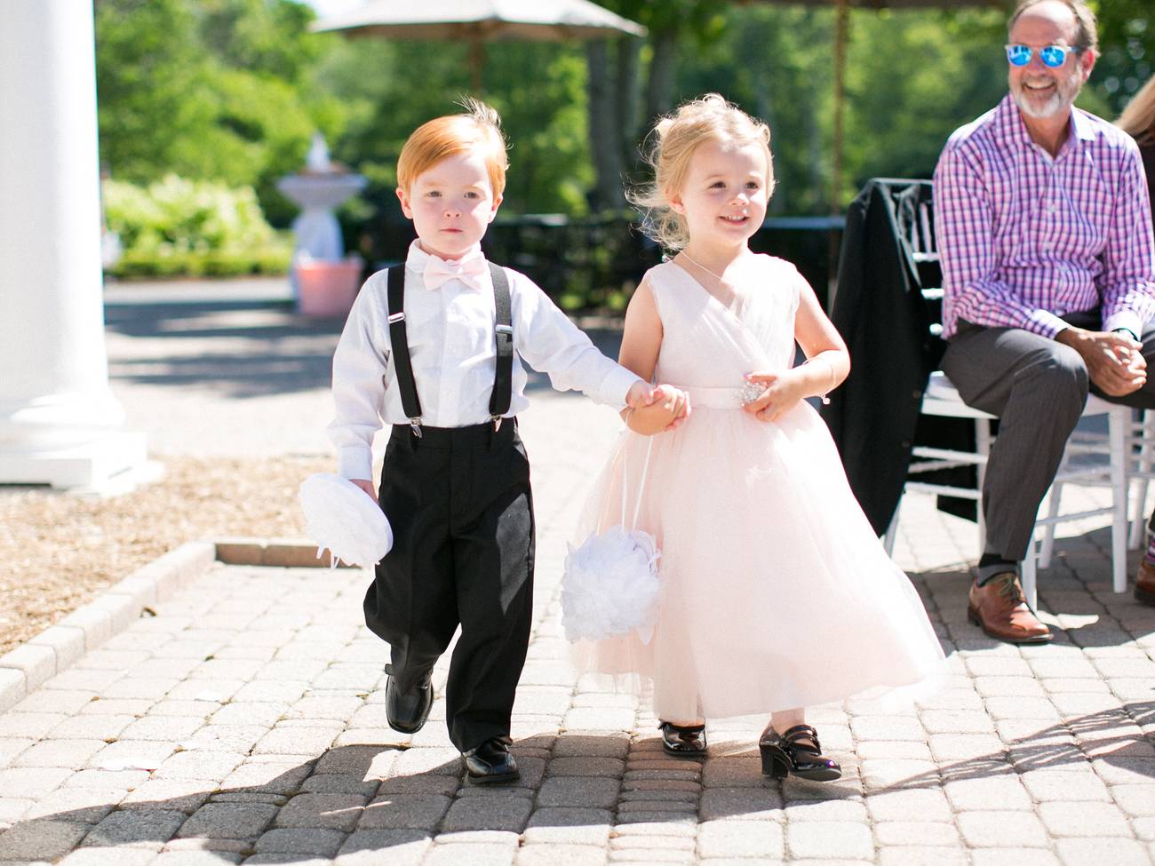 Two kids walking and holding hands