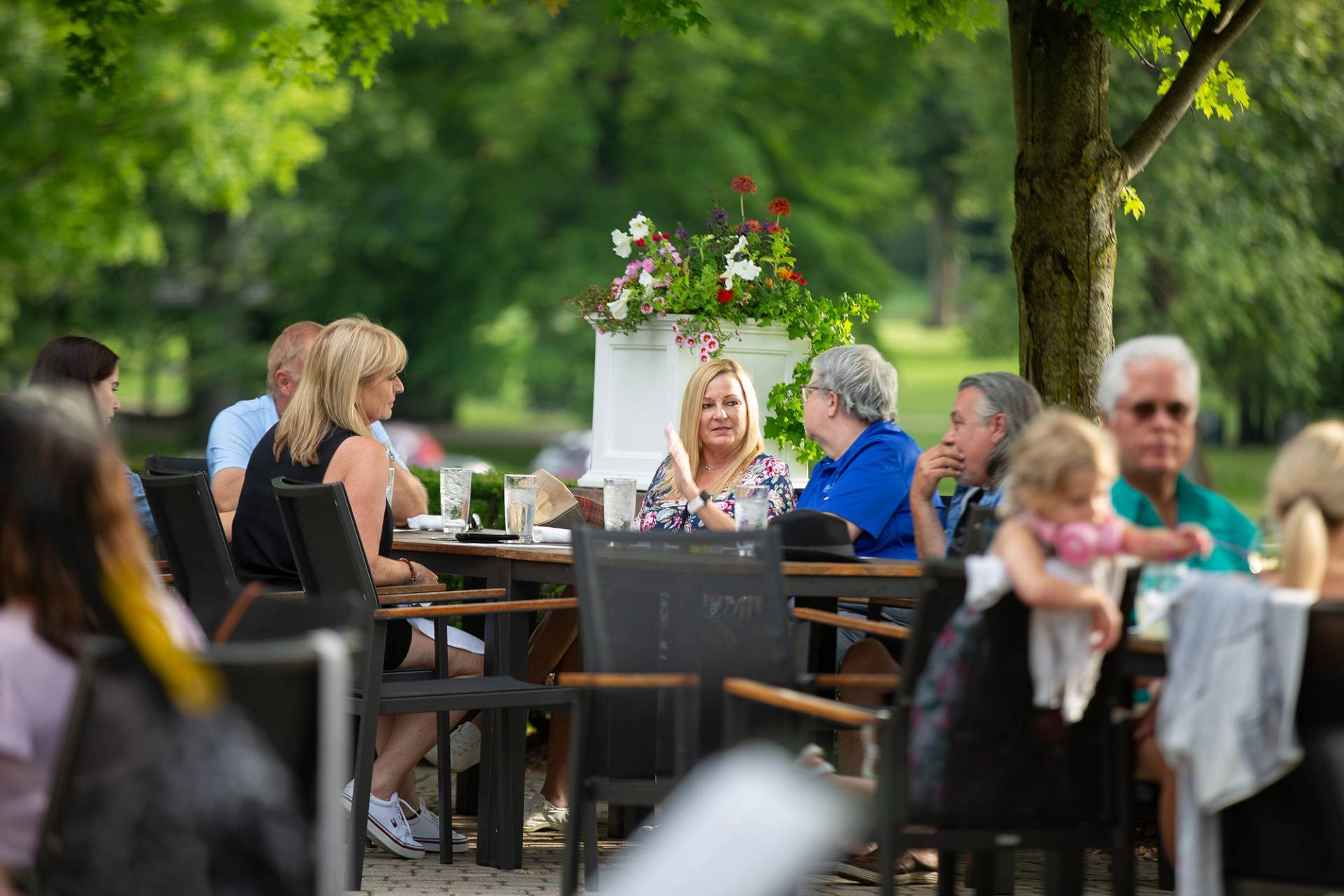 A group of people eating on a patio