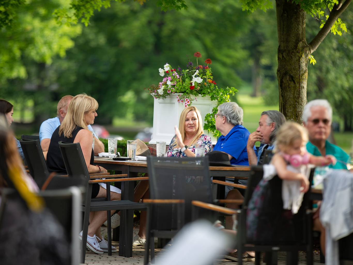 A group of people eating on a patio
