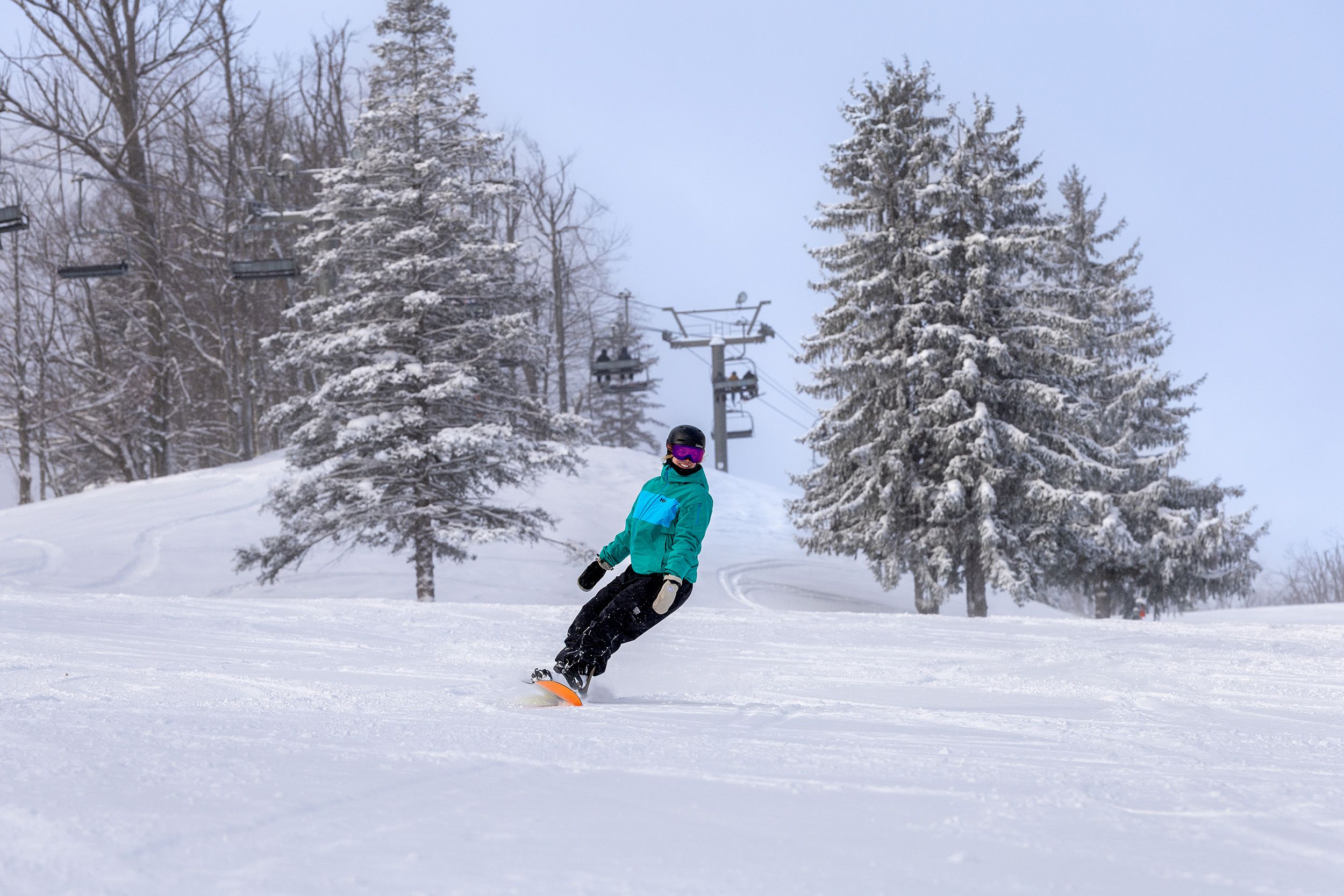 A woman snowboarding at The Highlands