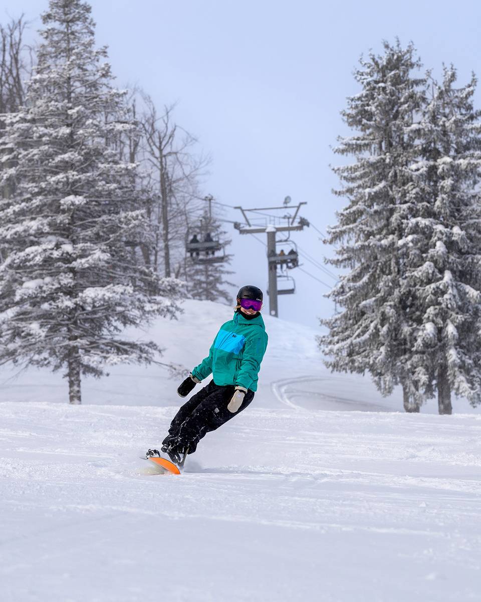A woman snowboarding at The Highlands