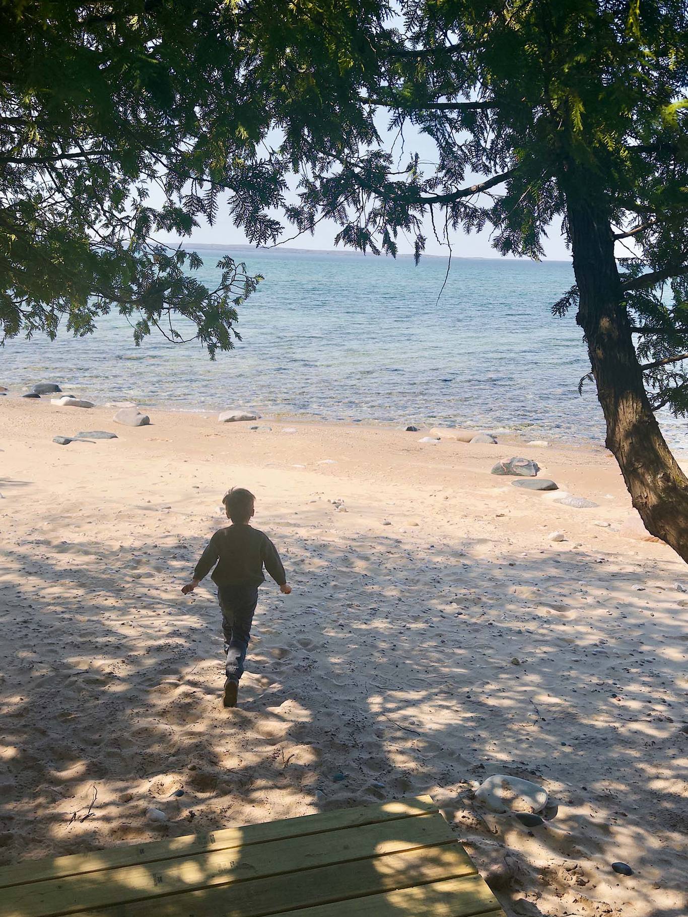 A child on the beach at the Thorn Swift Nature Preserve