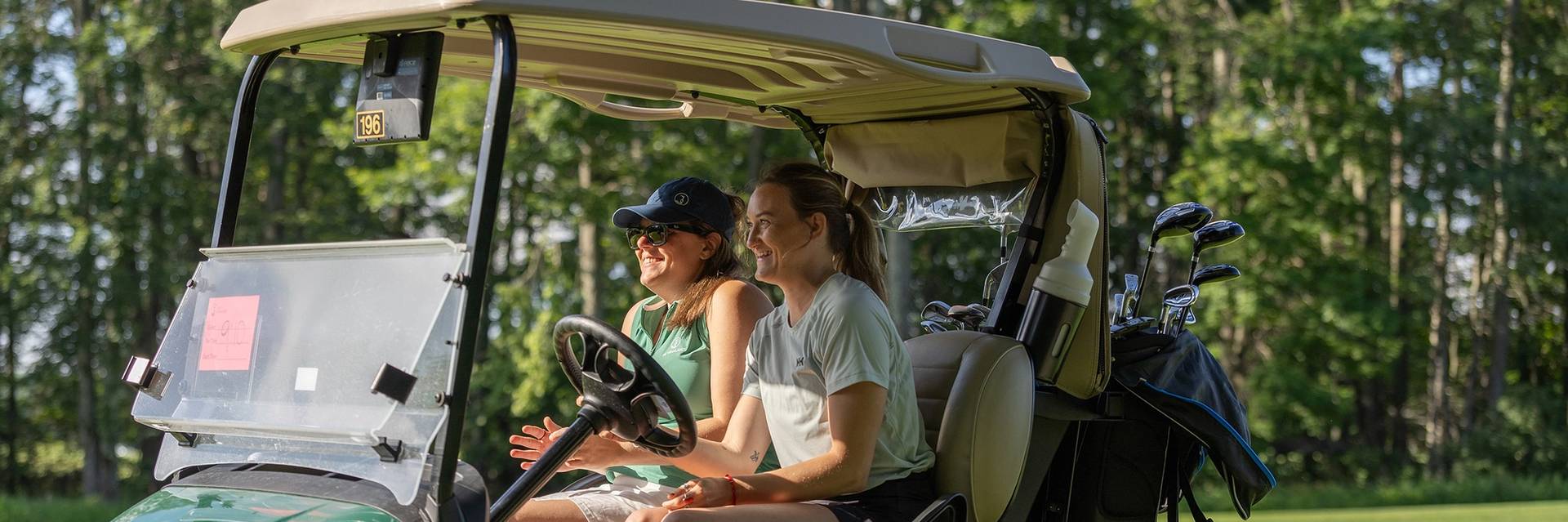 Two women in a golf cart