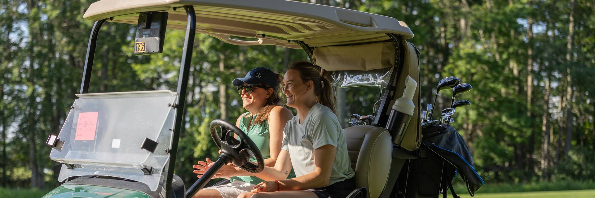 Two women in a golf cart
