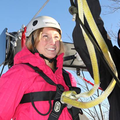 A woman in zipline gear