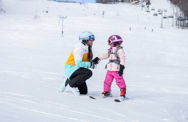 A mom and daughter in ski gear