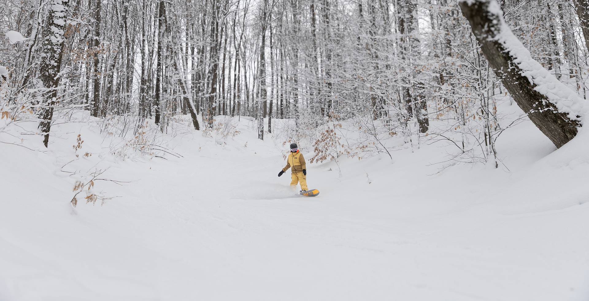 A woman snowboarding at The Highlands