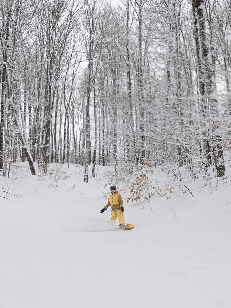 A woman snowboarding at The Highlands