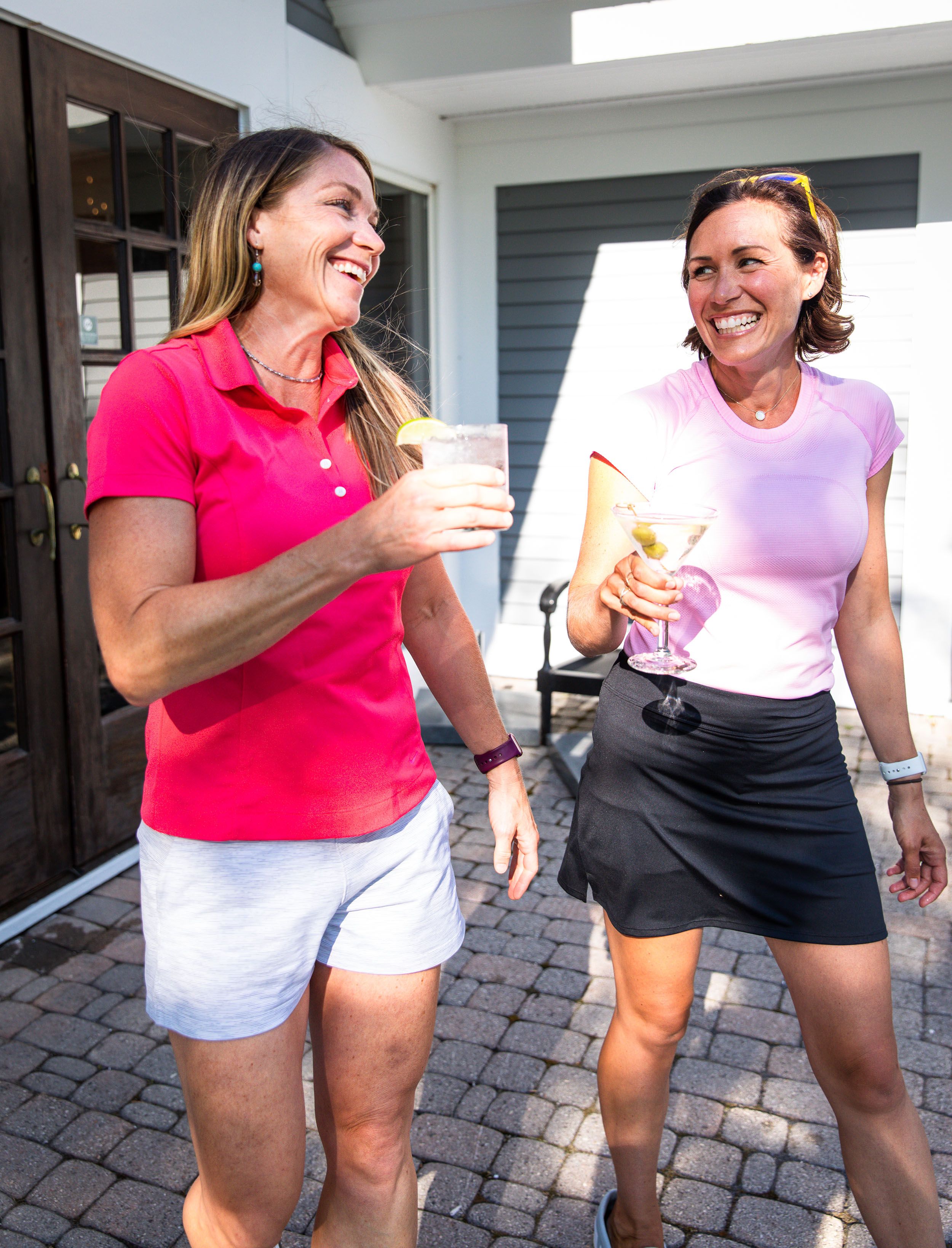 Two women holding cocktails