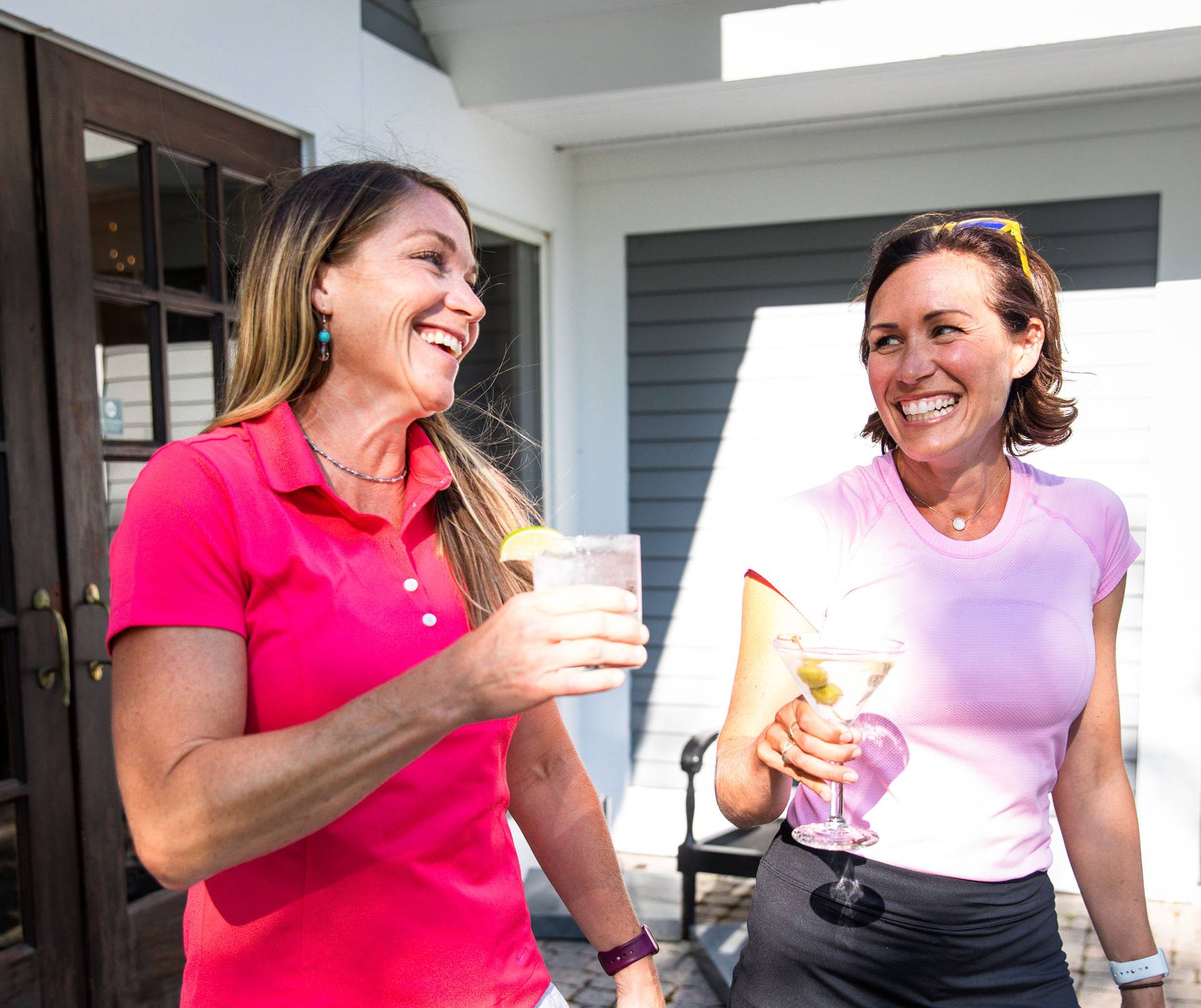 Two women holding cocktails