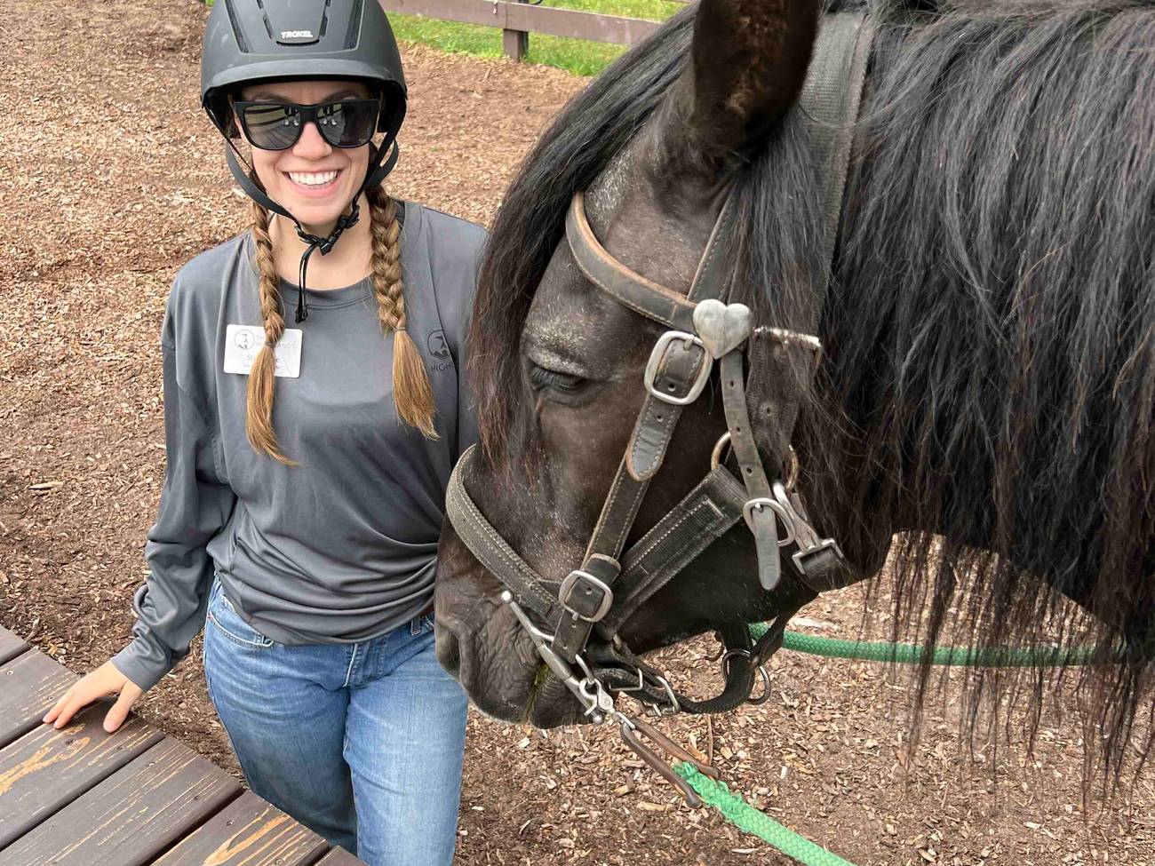 A woman posing with a horse at The Highlands