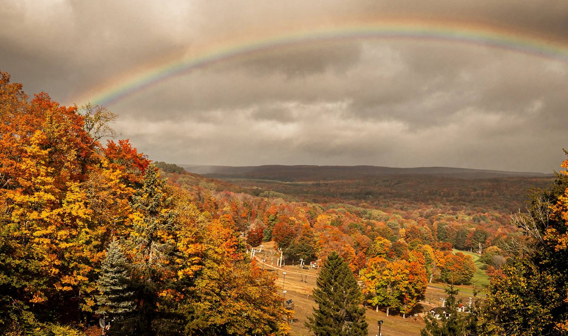 A rainbow over the fall trees at The Highlands