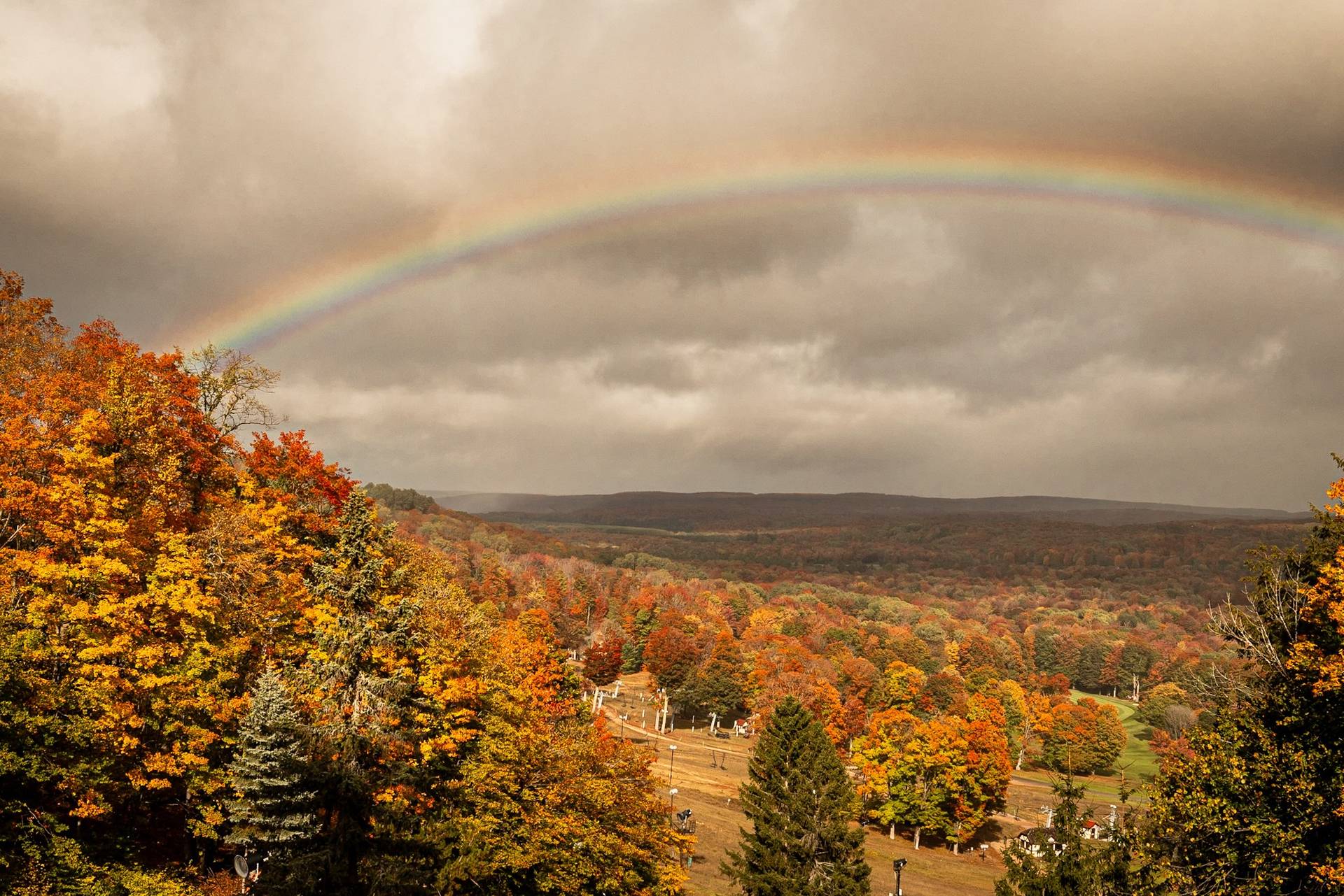A rainbow over the fall trees at The Highlands