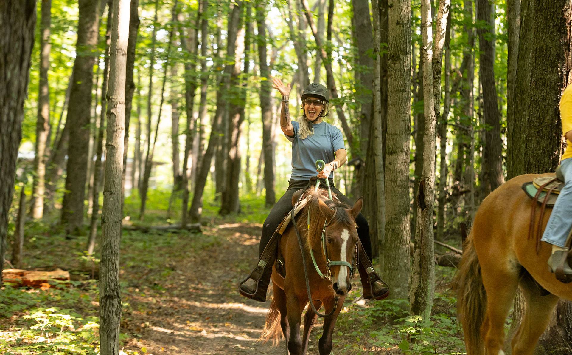 A team member smiling on a horse
