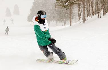 A snowboarder on a powder day at The Highlands
