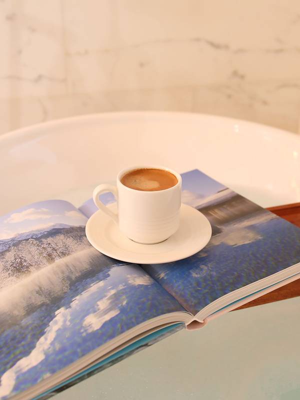 A cup of coffee and an open book