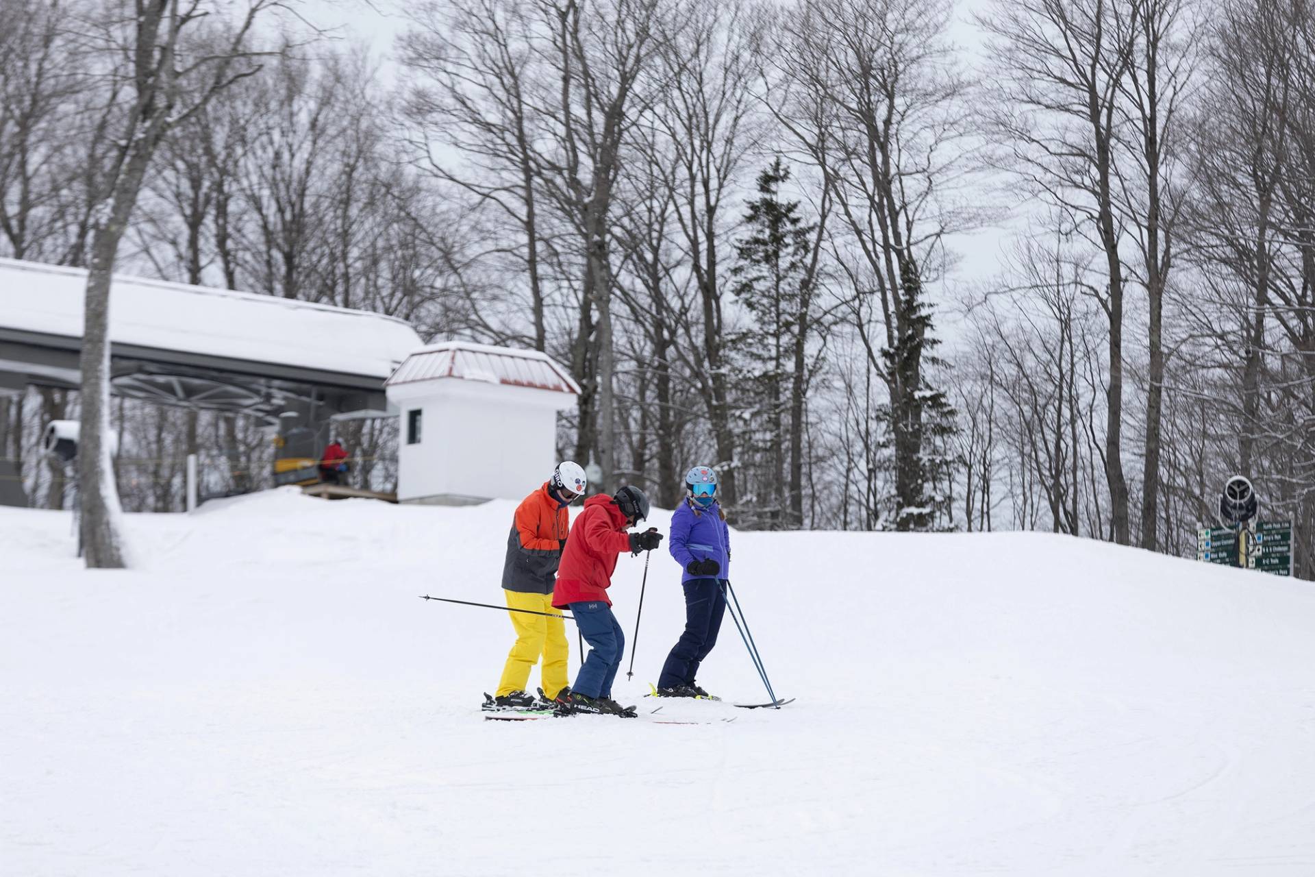 A group of adults taking a ski lesson