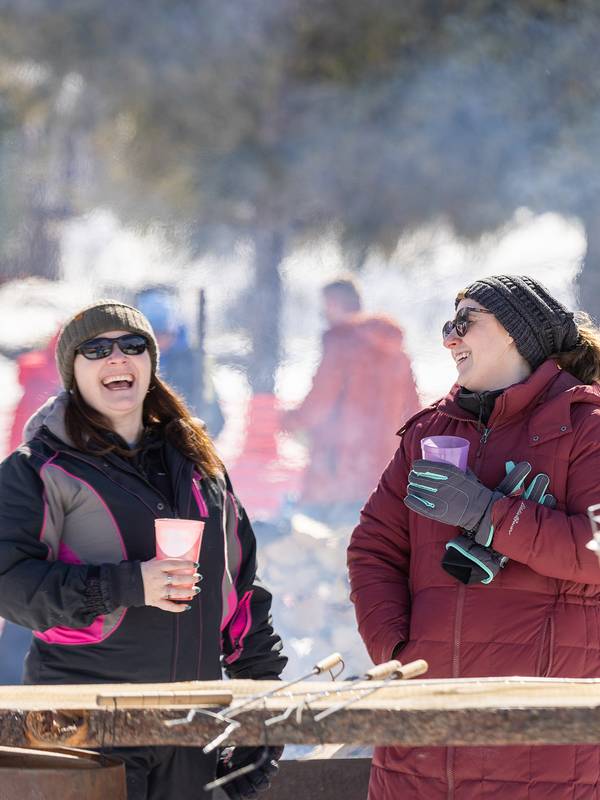 Two women smiling at the Hops 'N Highland event