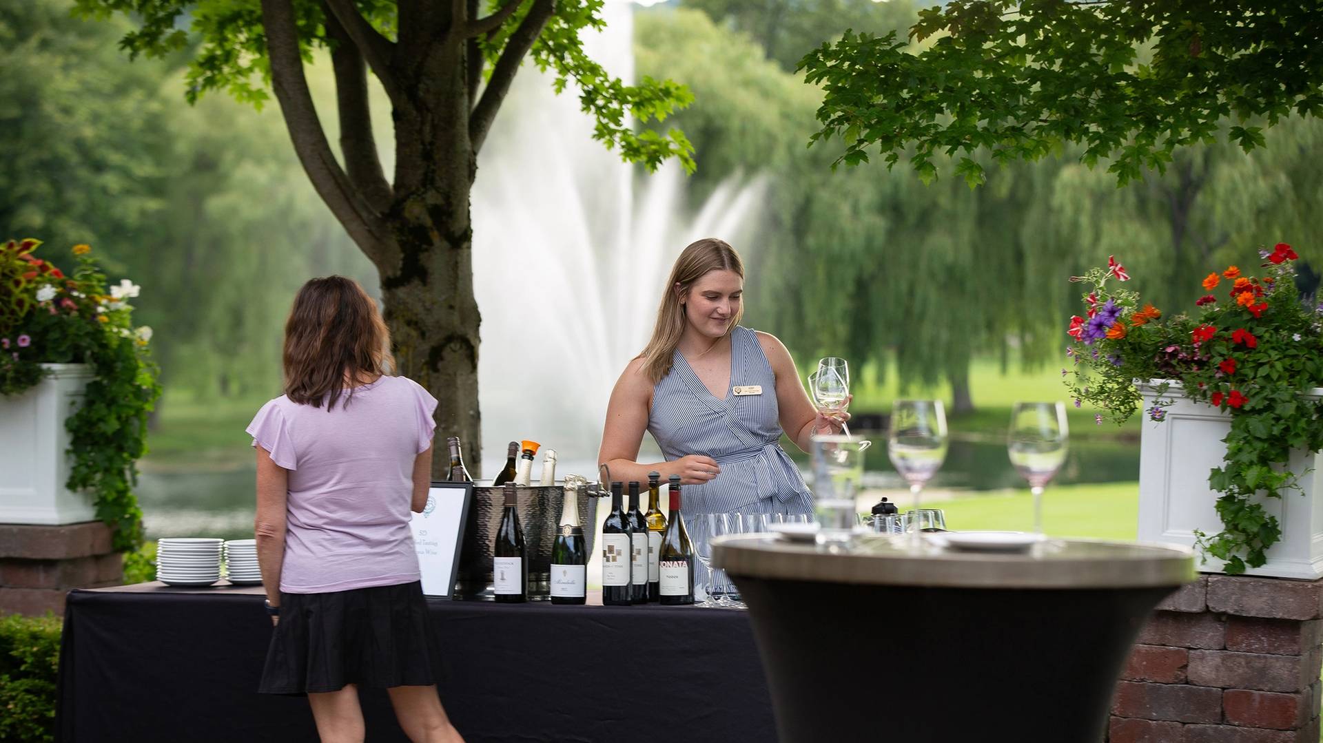 A woman holding wine glasses