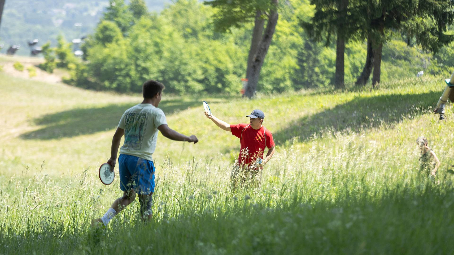 Two men playing disc golf at The Highlands