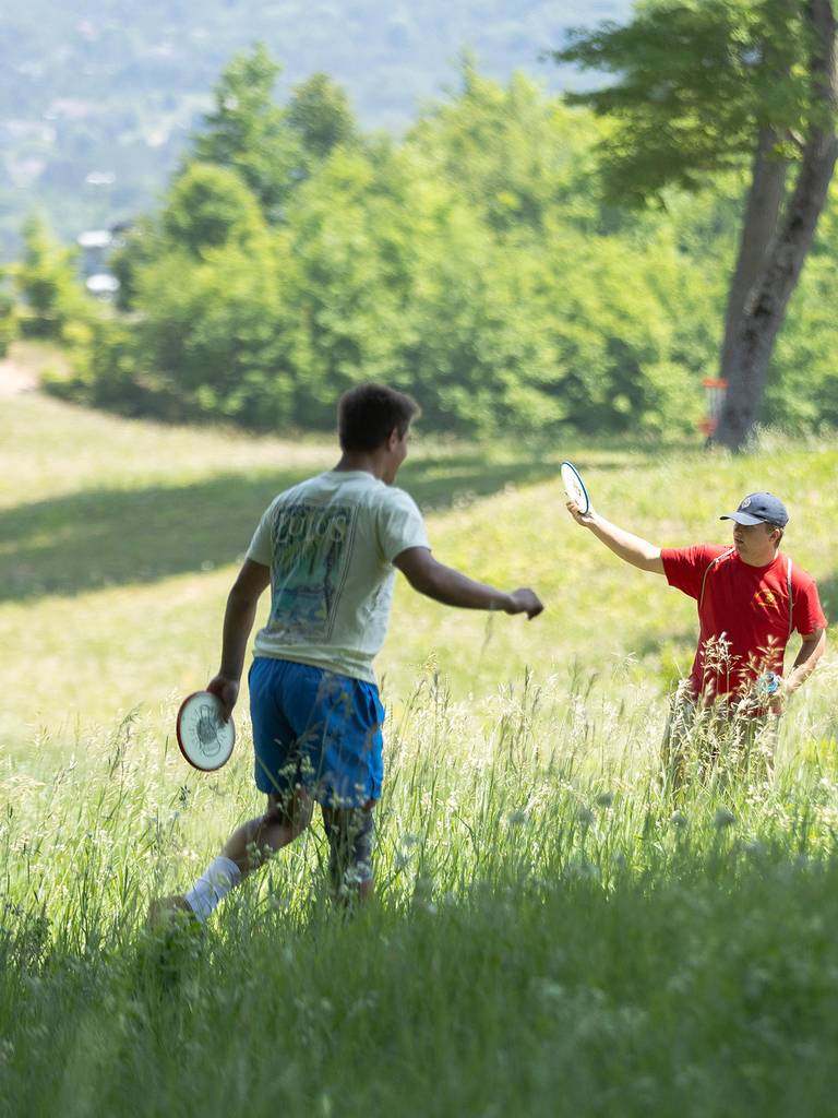Two men playing disc golf at The Highlands