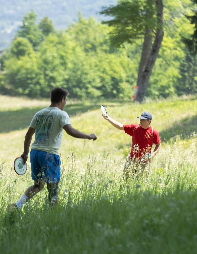Two men playing disc golf at The Highlands