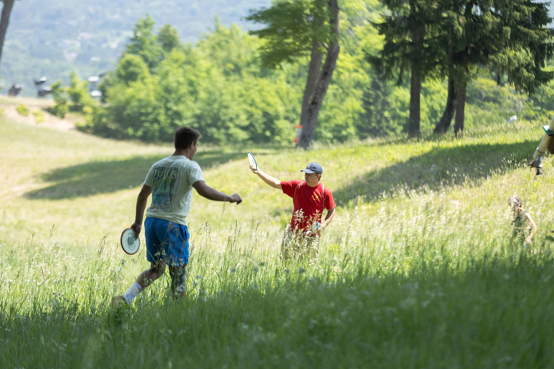 Two men playing disc golf at The Highlands