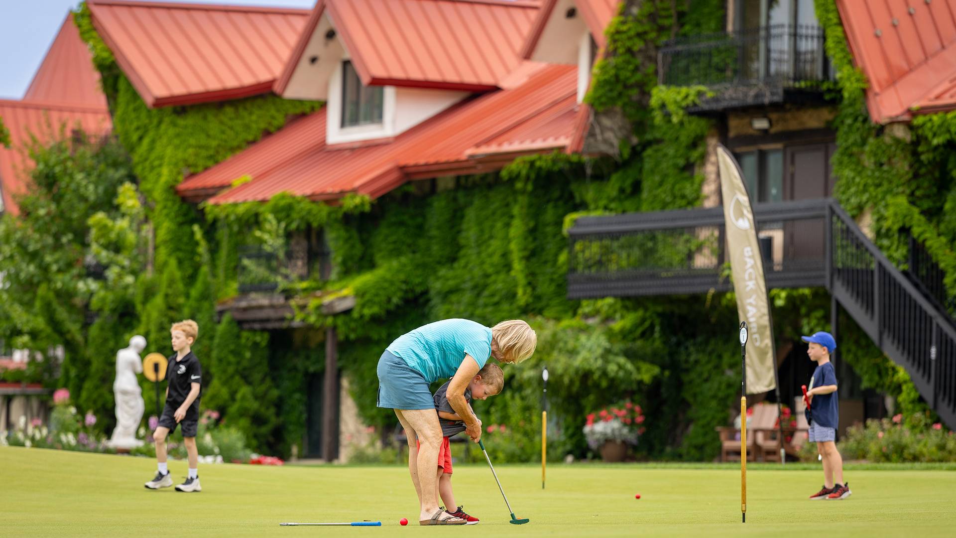 A family putting on the Back Yaird Putting Green