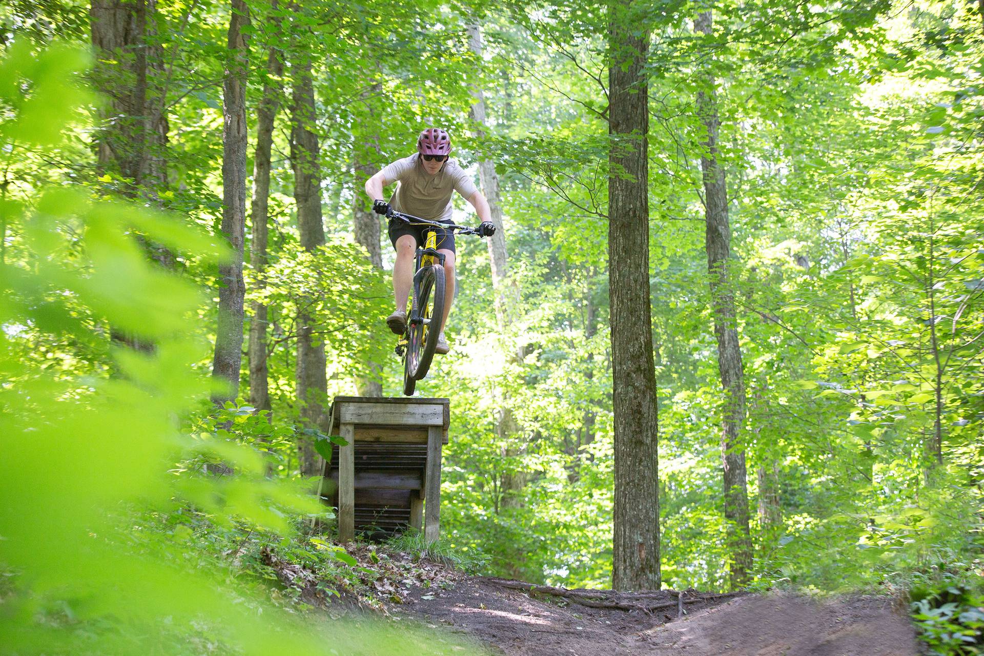 A mountain biker on a wooden jump
