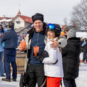 A couple smiling at the Hops 'N Highlands event