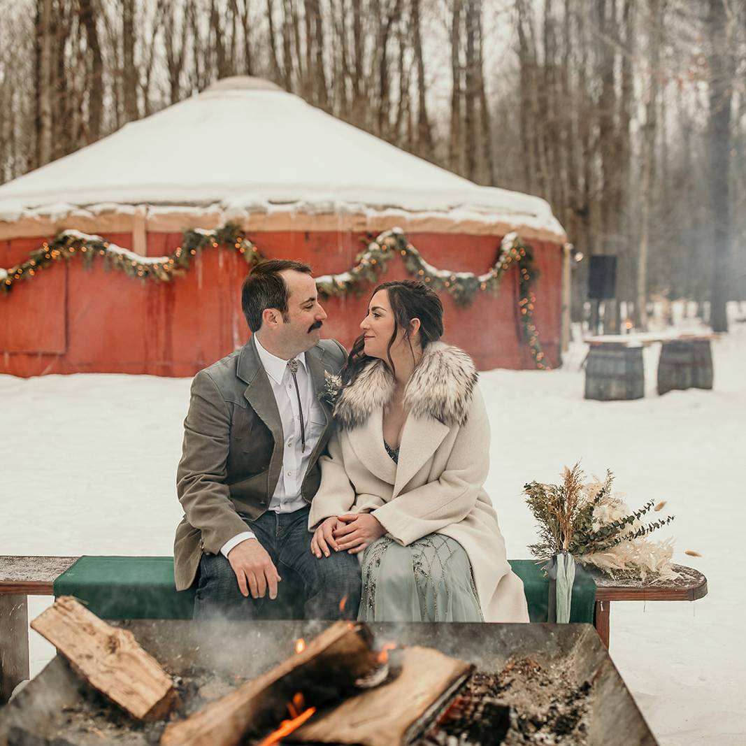 A couple posing near a bonfire